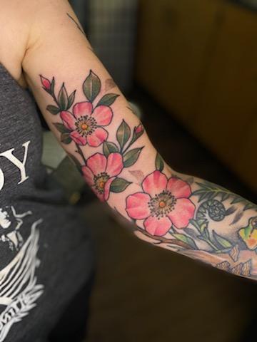 Tattoo of wild roses on inner arm